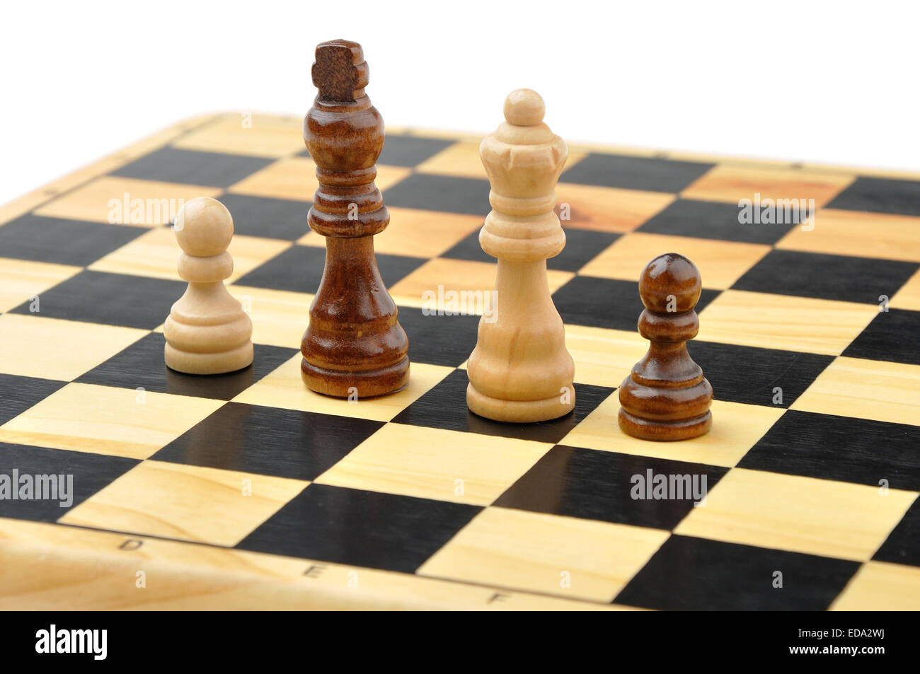 Chess figures king, queen and two pawns as concept of interracial family Stock Photo