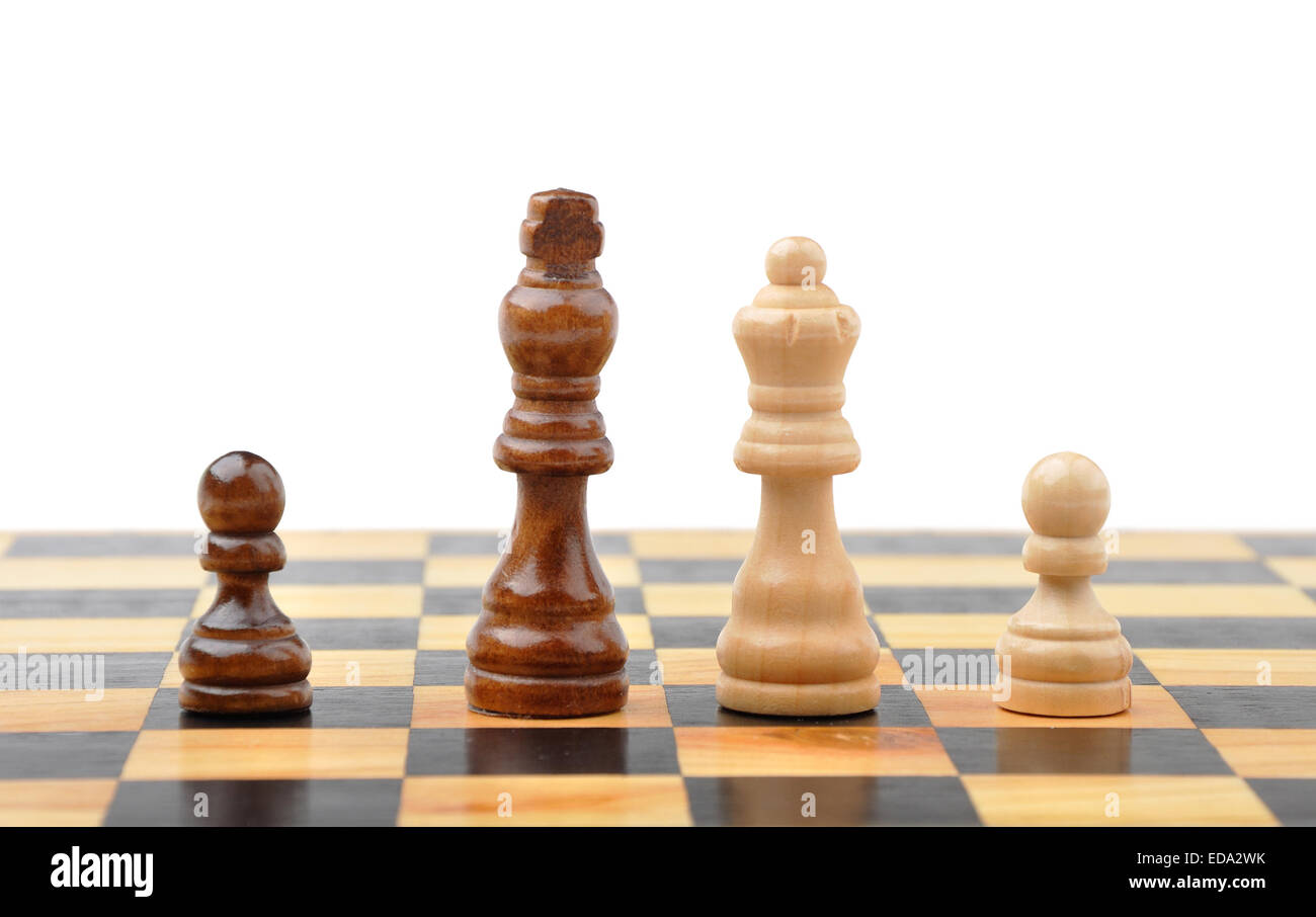 Chess figures king, queen and two pawns as concept of interracial family Stock Photo