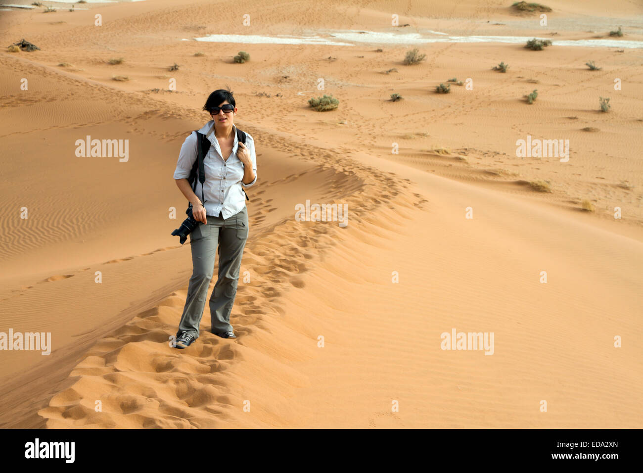 tourist woman is climbing a desert dune, Namibia Stock Photo - Alamy