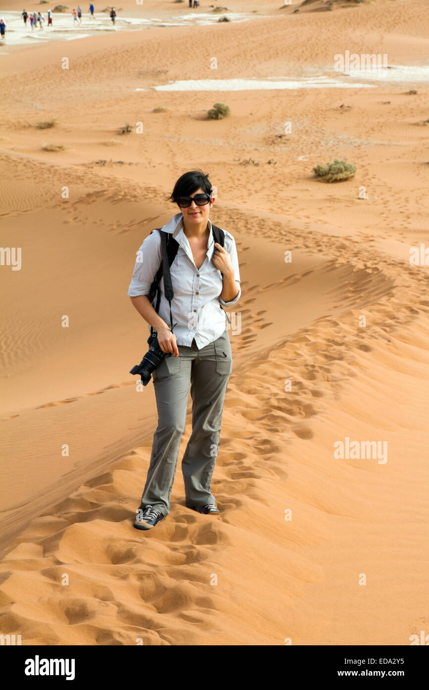 tourist woman is climbing a desert dune, Namibia Stock Photo - Alamy