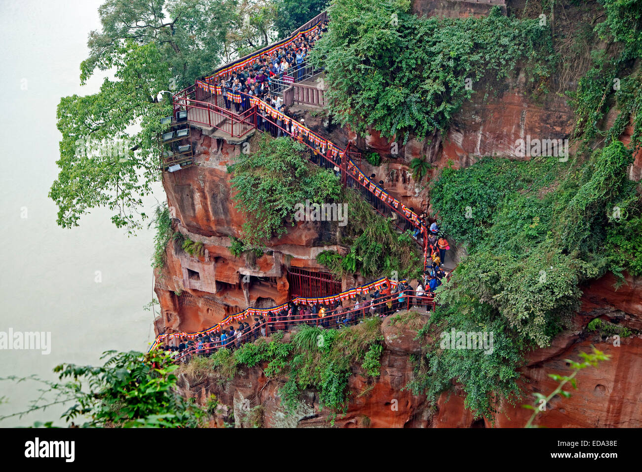 Queue of Chinese tourists walking down the stairs to see the Leshan Giant Buddha, stone-carved statue in Sichuan province, China Stock Photo