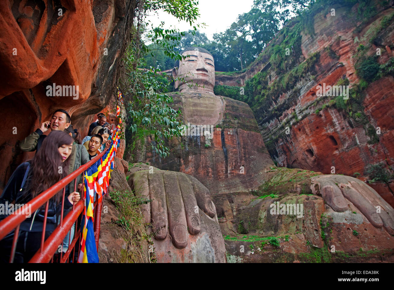 Queue of Chinese tourists walking down the stairs to see the Leshan Giant Buddha, stone-carved statue in Sichuan province, China Stock Photo