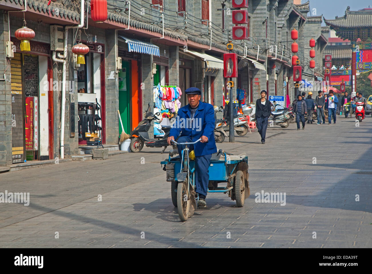 Chinese man riding bicycle cart in the city Zhaotong, Yunnan province, China Stock Photo