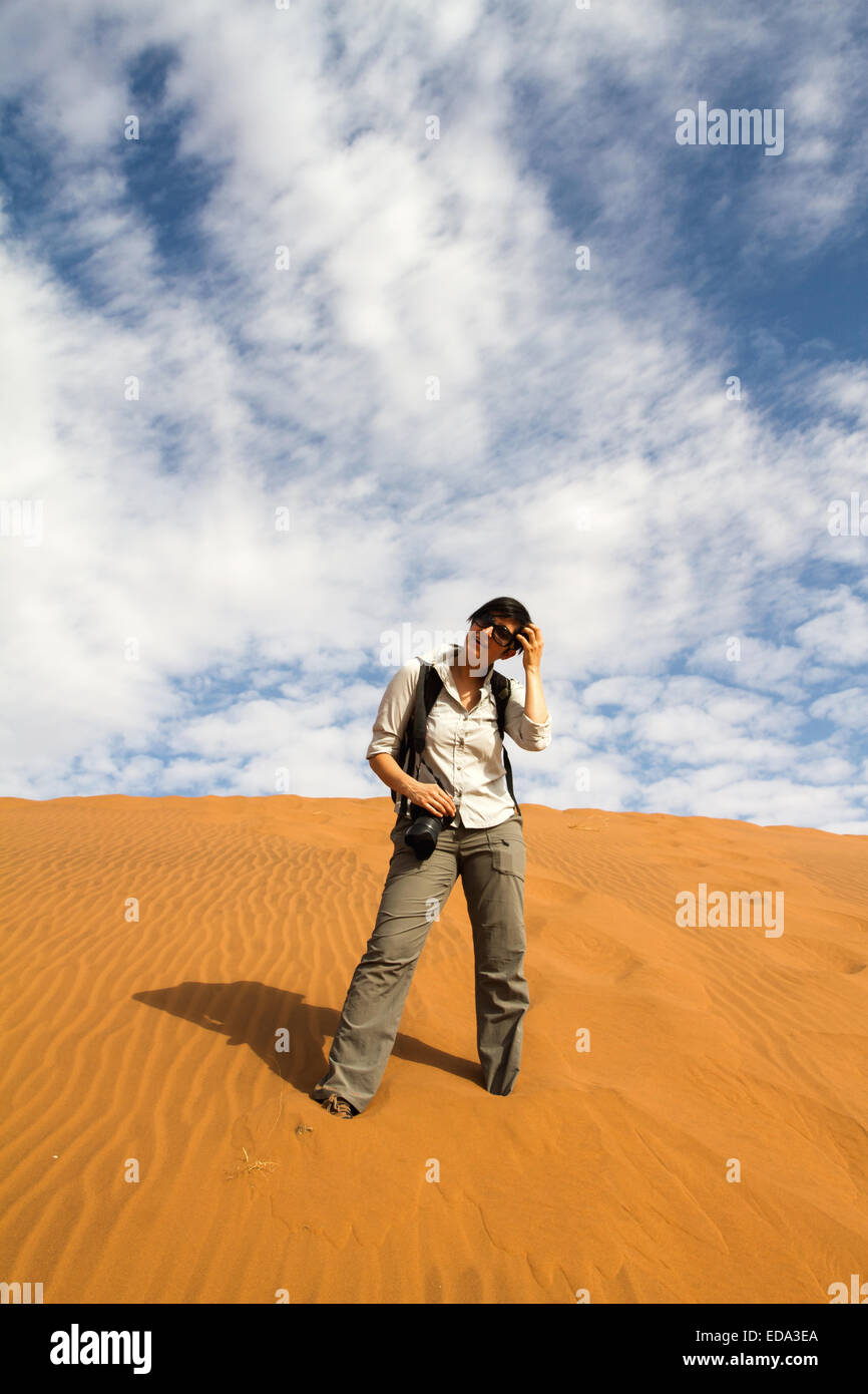 tourist woman is climbing a desert dune, Namibia Stock Photo - Alamy