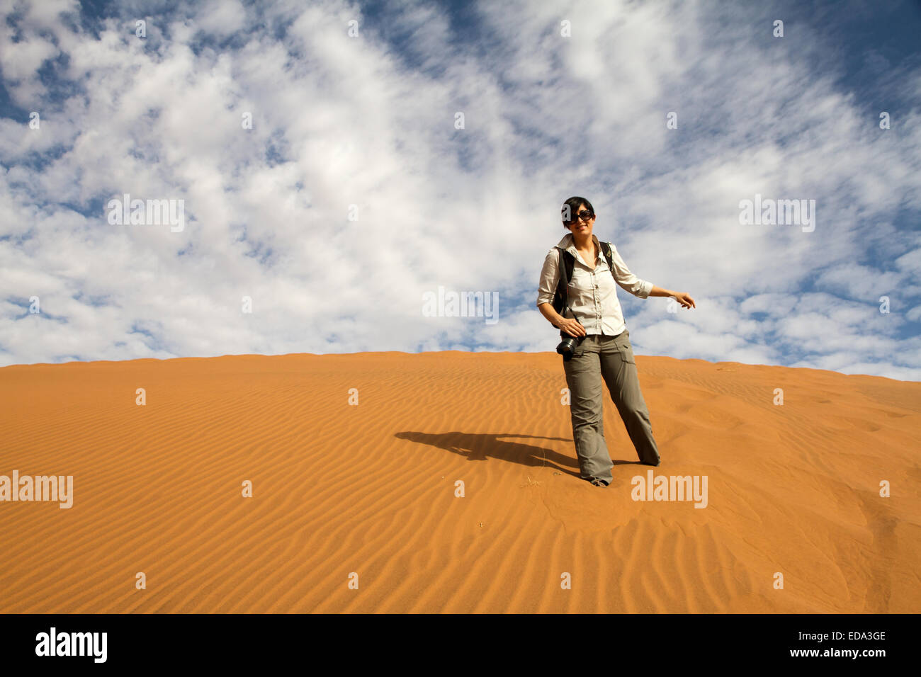 tourist woman is climbing a desert dune, Namibia Stock Photo - Alamy