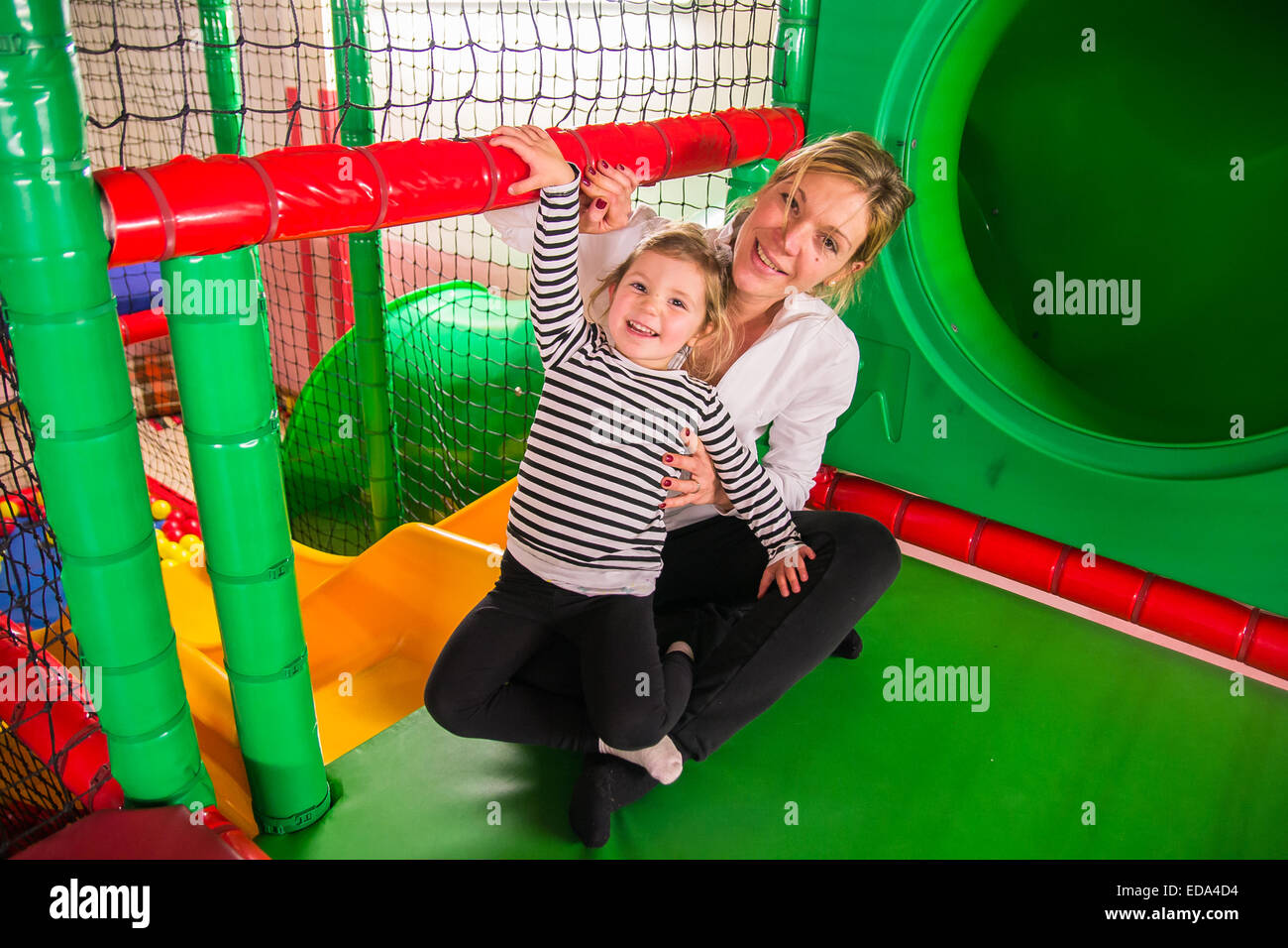 Mom and daughter in indoor playroom Stock Photo