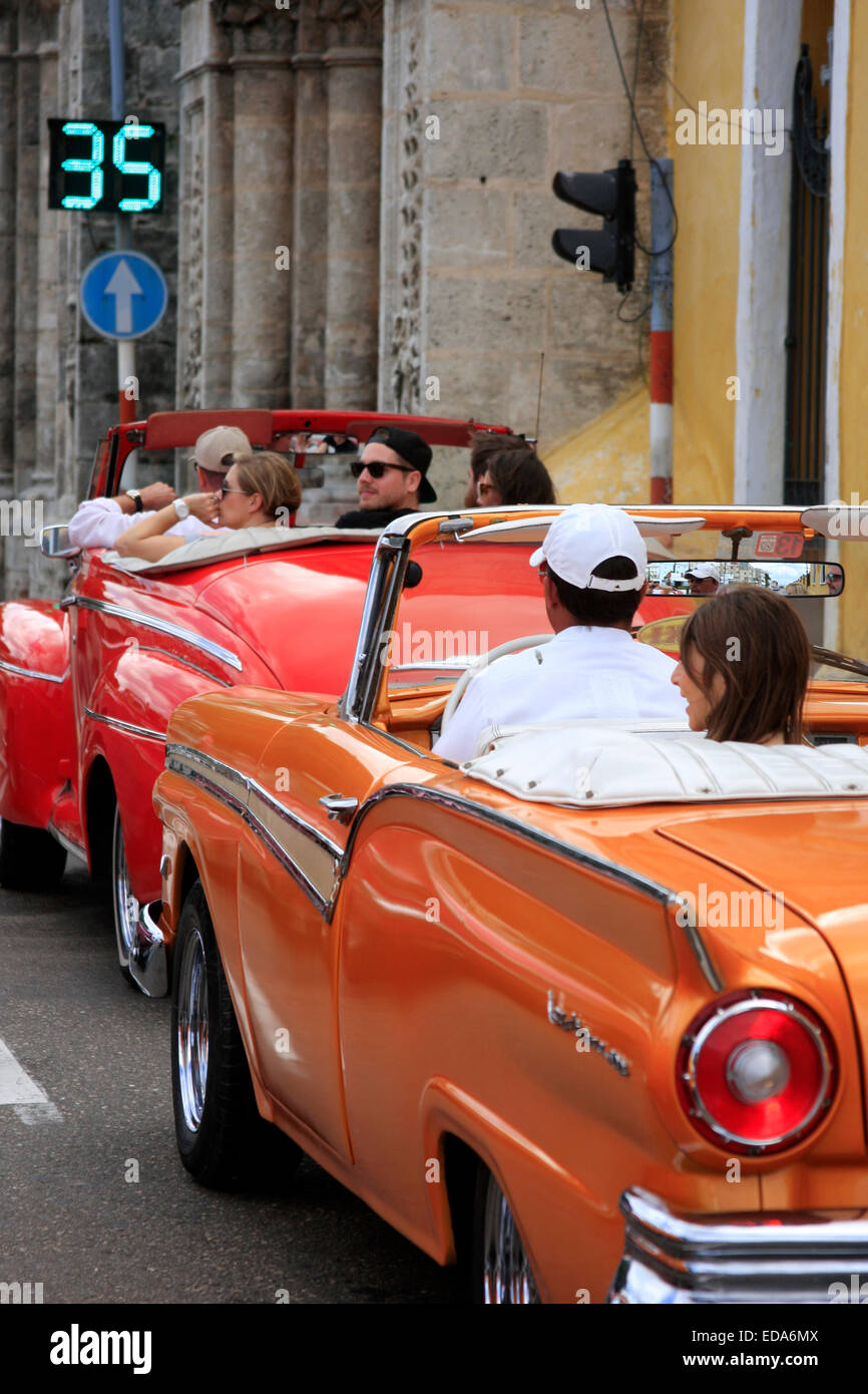 Vintage American cars waiting at traffic lights in old Havana on the island of Cuba Stock Photo