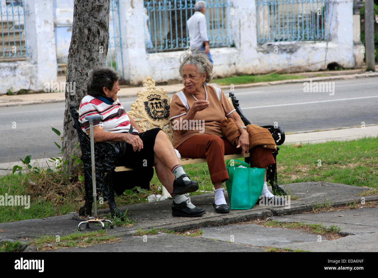 Two Cuban ladies sitting in a town square talking in the Vedado district  of Havana Stock Photo
