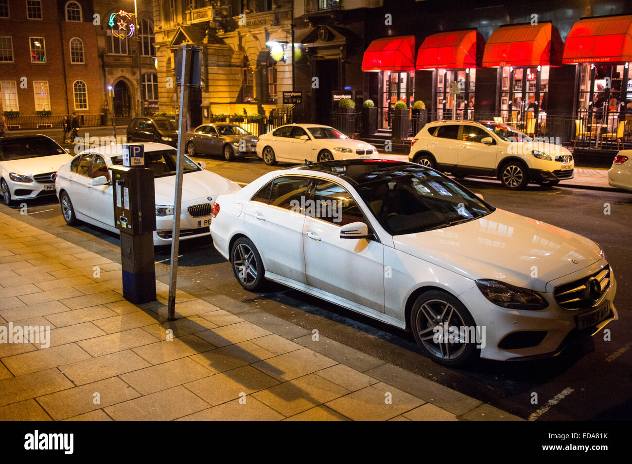 White cars parked up at night on South Parade street in Leeds city