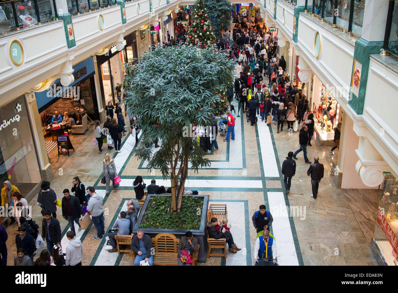 People shopping and spending inside the Intu Trafford Centre indoor shopping complex in Dumplington, Greater Manchester, England Stock Photo