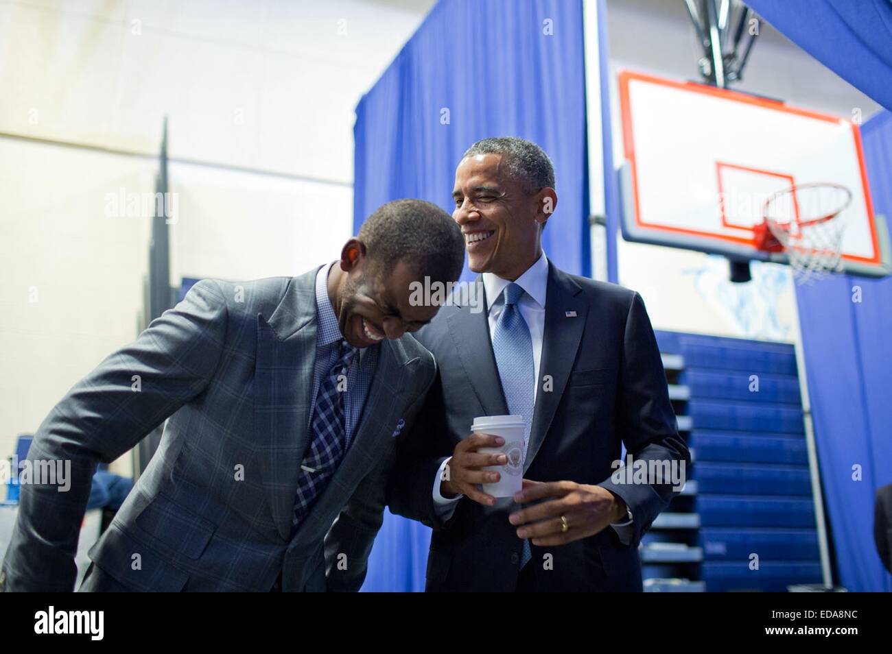 US President Barack Obama shares a laugh backstage with Los Angeles Clippers basketball player Chris Paul, who was about to introduce the President at a My Brother's Keeper initiative town hall July 21, 2014 in Washington, DC. Stock Photo