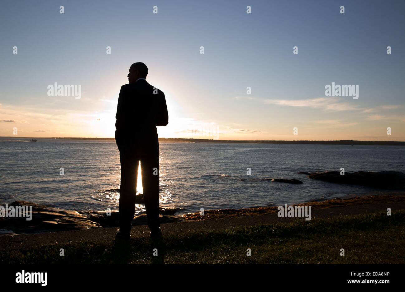 US President Barack Obama takes in the sunset over the water at Brenton Point August 29, 2014 in Newport, Rhode Island. Stock Photo