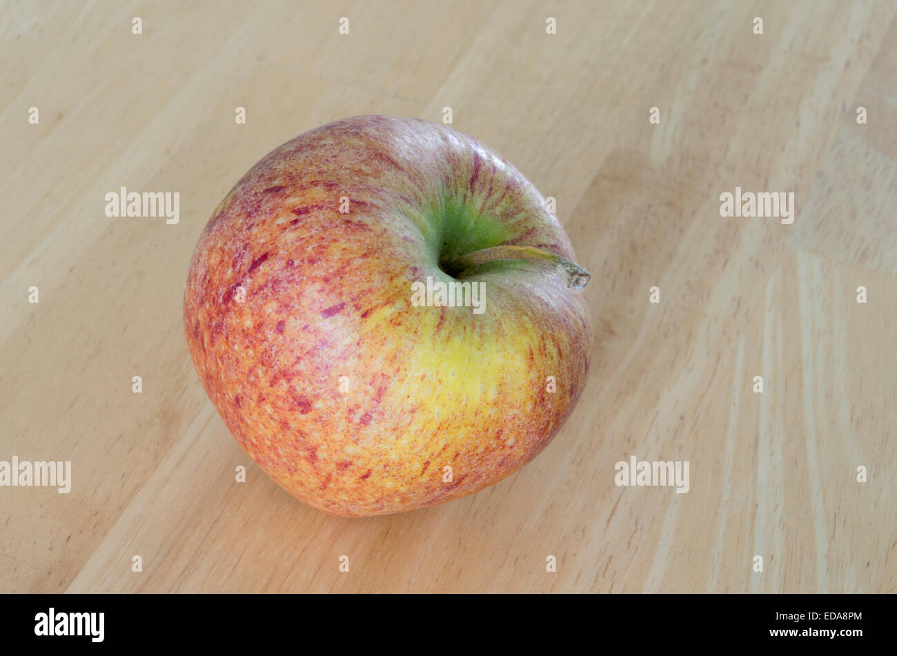 Apple ( Malus x domestica ) cultivar 'Cameo' on a Wooden Background Stock Photo