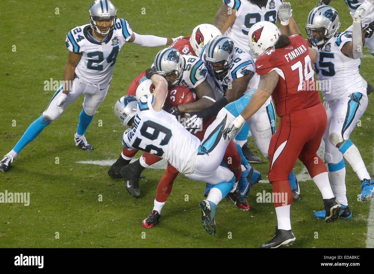 Charlotte, NC, USA. 3rd Jan, 2015. The Carolina Panthers defense swarms Arizona Cardinals running back Kerwynn Williams #33 in the NFC wildcard game on January 3, 2015, at Bank of America Stadium in Charlotte, North Carolina. The Panthers defeated the Cardinals 27-16. Margaret Bowles/CSM/Alamy Live News Stock Photo