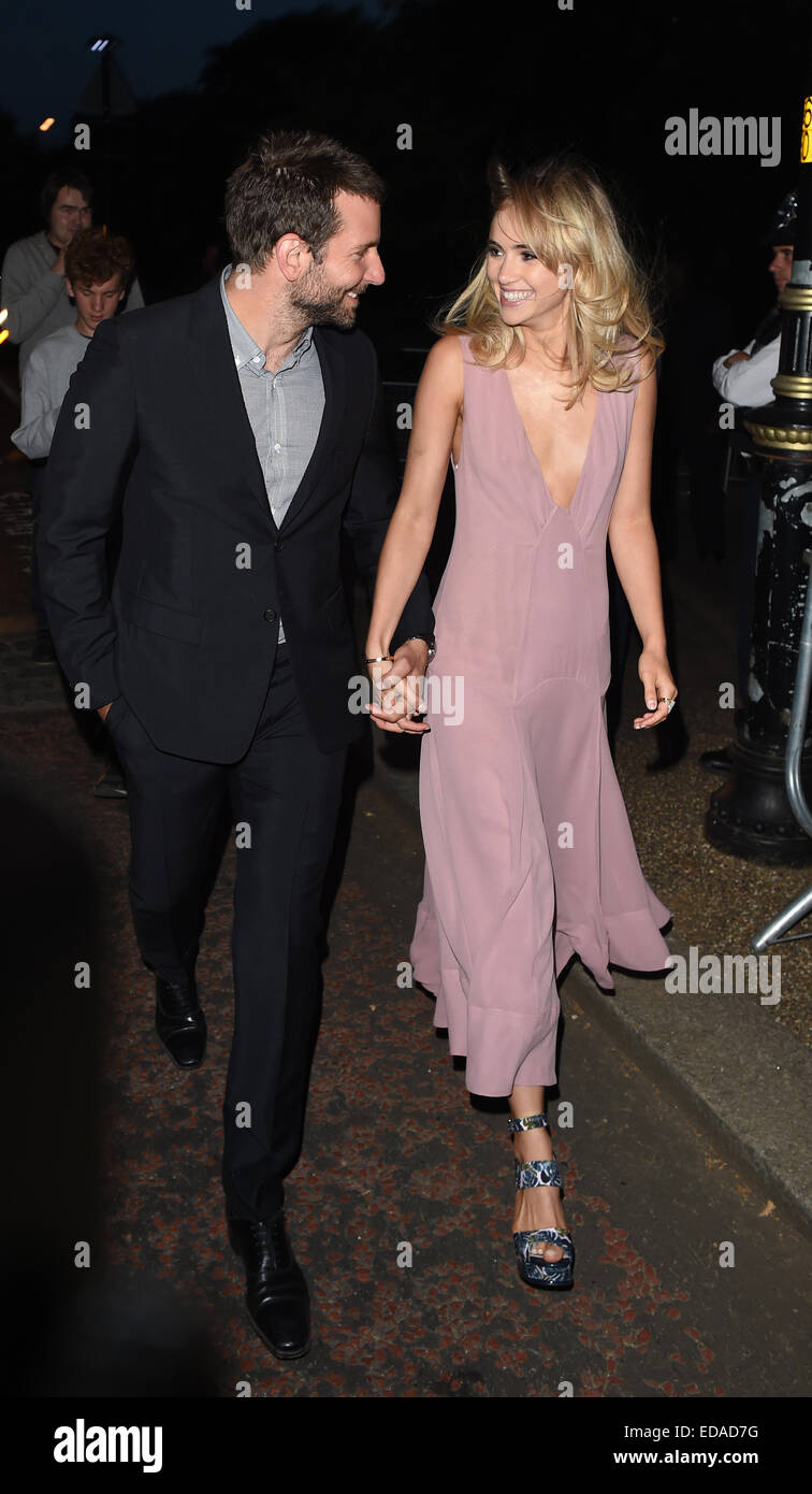 Bradley Cooper and Suki Waterhouse hold hands and smile at each other