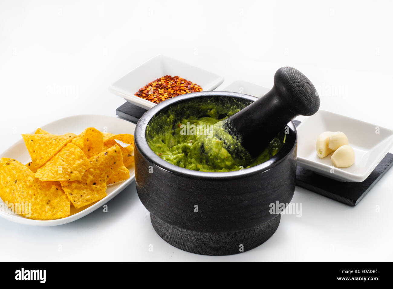 Pestle and Mortar filled with avocado and chili pepper garlic for