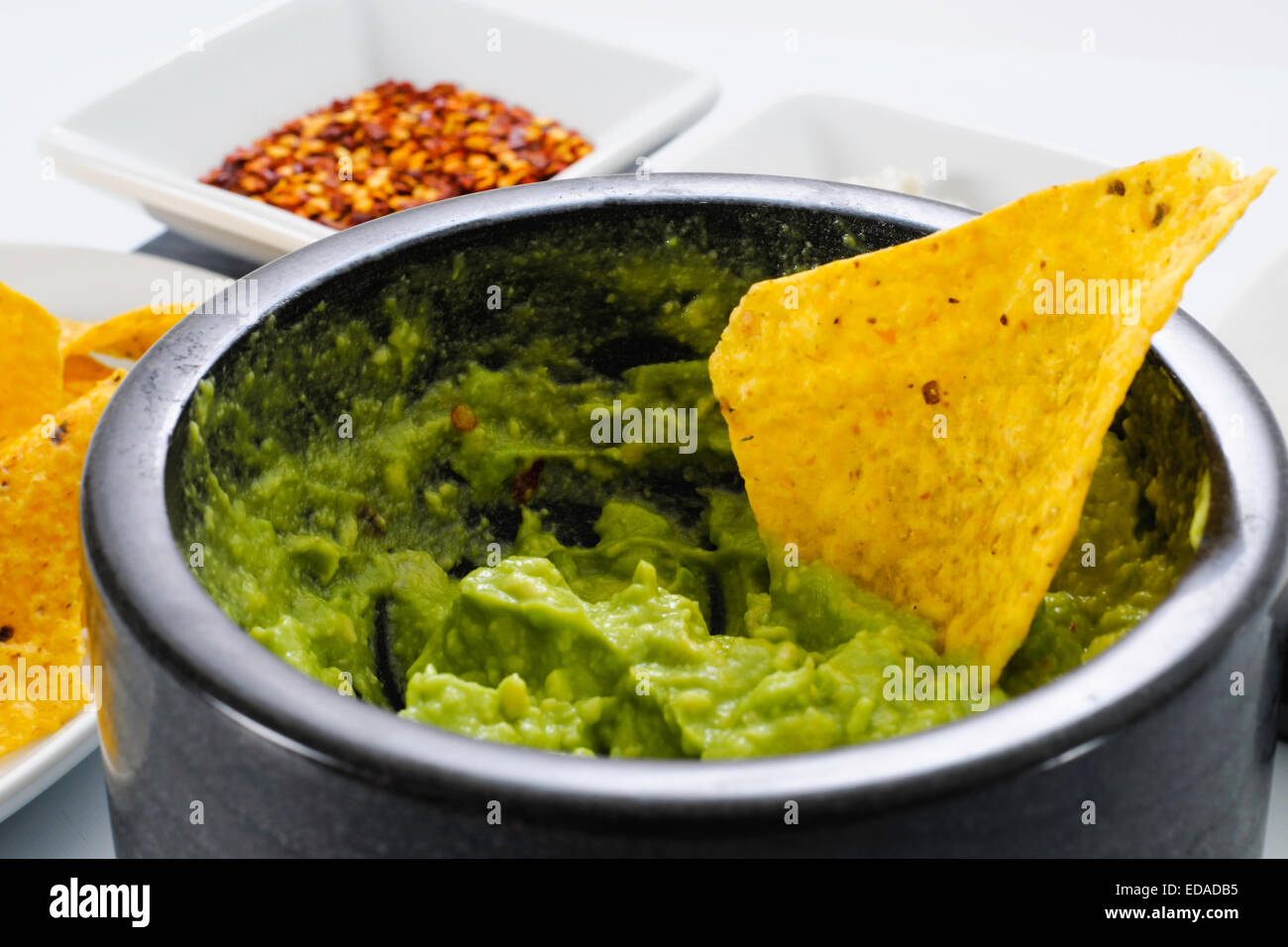 Pestle and Mortar filled with avocado and chili pepper spices for ...