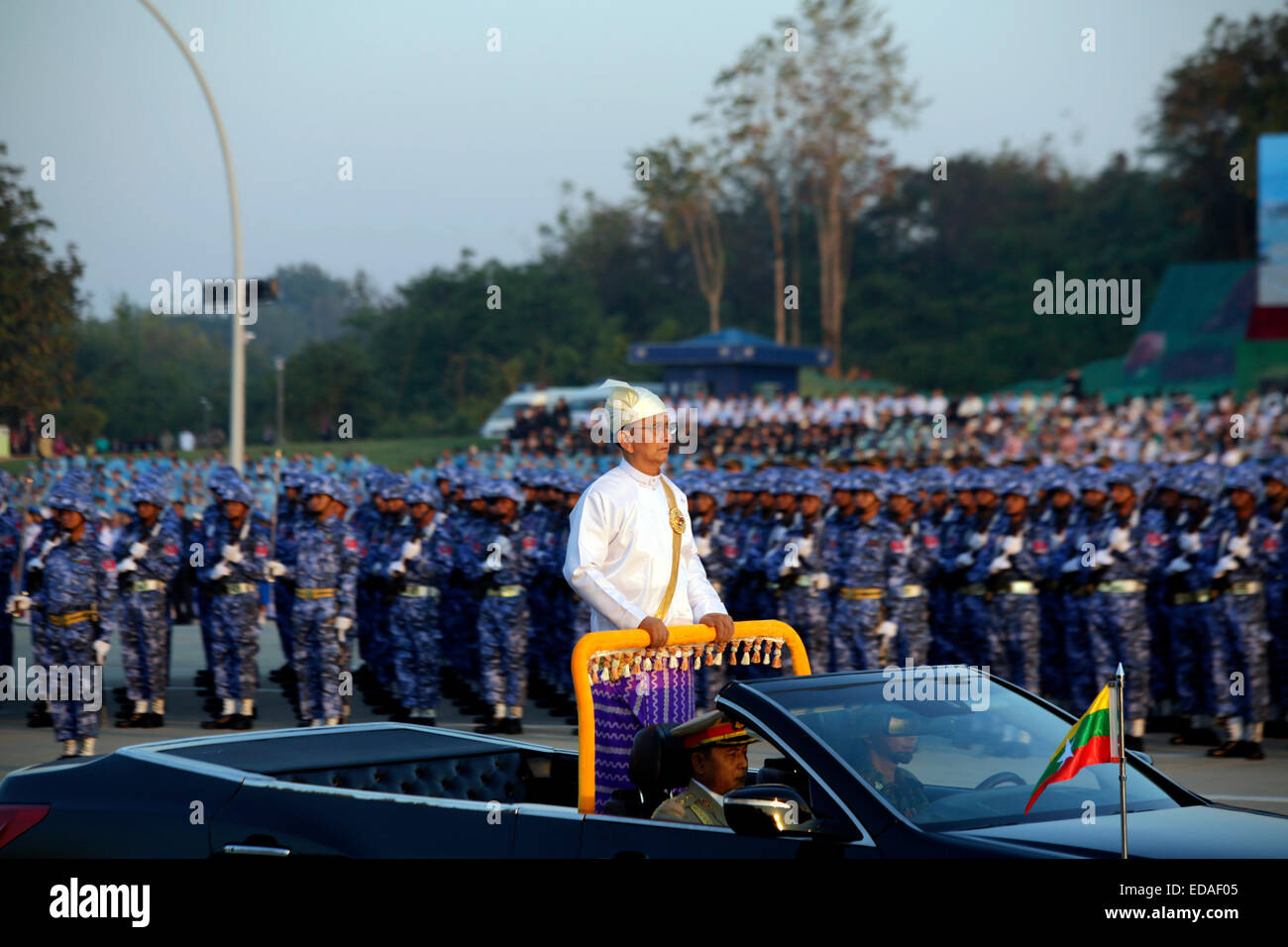 Nay Pyi Taw, Myanmar. 4th Jan, 2015. Myanmar President U Thein Sein (C) stands on vehicle as he inspects soldiers during a ceremony to mark the 67th anniversary of Myanmar's Independence day in Nay Pyi Taw, Myanmar, Jan. 4, 2015. Myanmar resumed military parade and mass procession Sunday to celebrate the country's Independence Day for the first time in over five decades since the end of 1950s. Credit:  U Aung/Xinhua/Alamy Live News Stock Photo