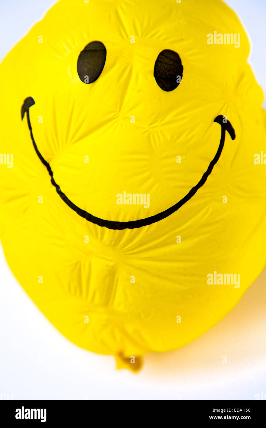 old Balloon, yellow, shriveled with friendly smiley face, sunken ...