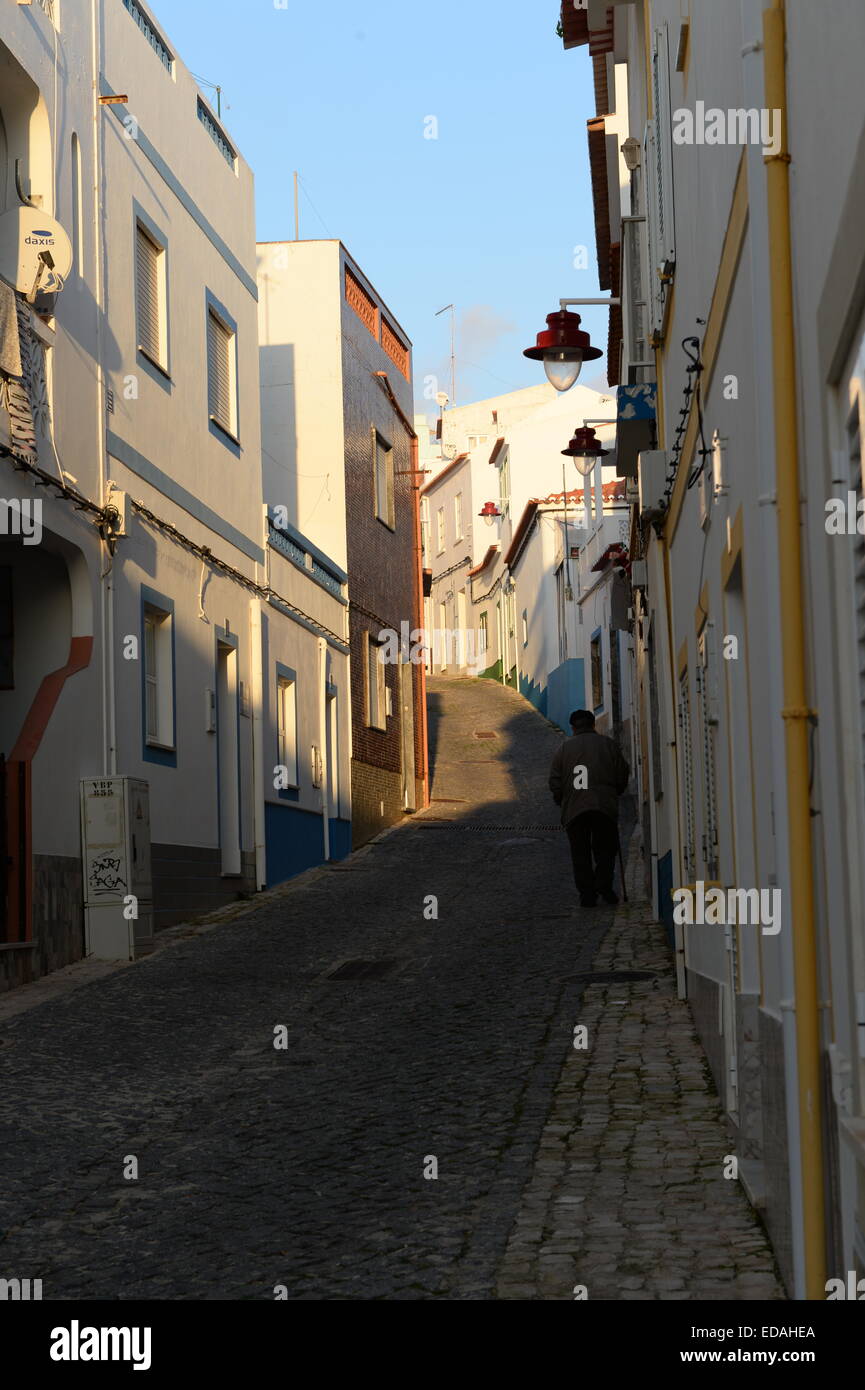Rue de Pescadores cobbled street with old person in the Algarve Stock Photo