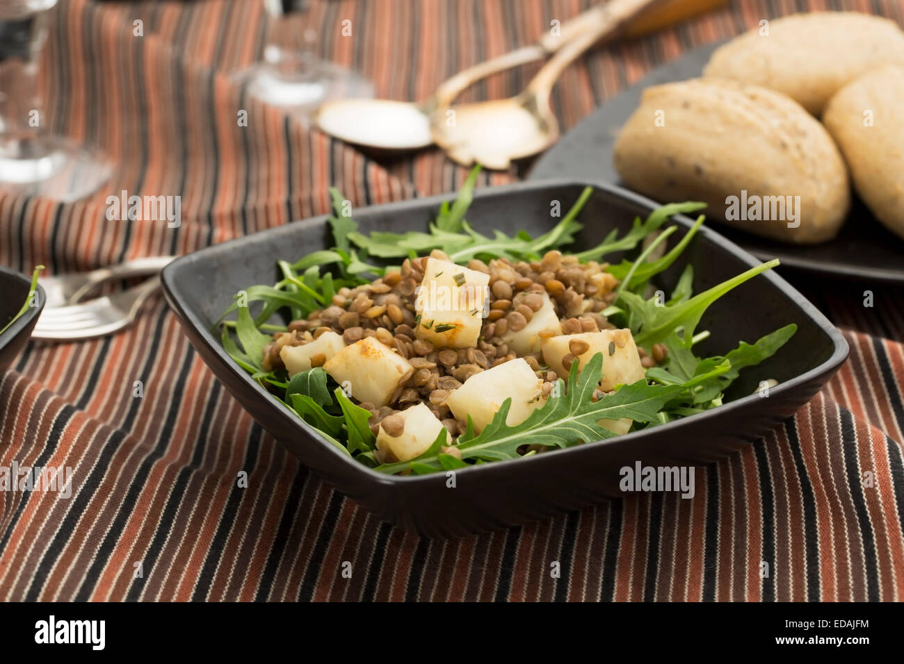 Healthy lentil and celeriac salad on rocket lettuce Stock Photo
