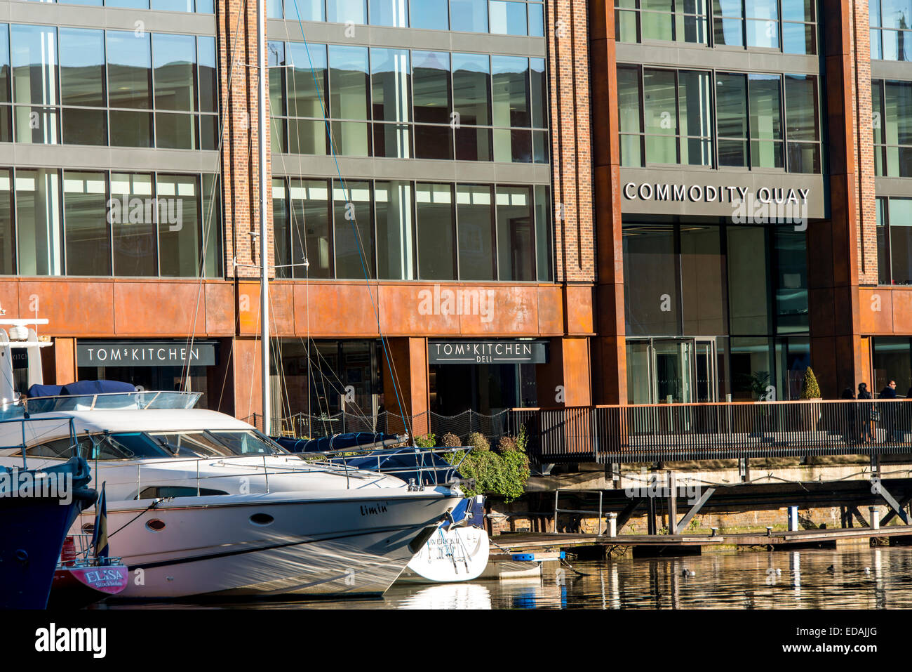 A luxury yacht moored in St Katharine Docks, East London, outside Tom's Kitchen restaurant and Commodity Quay office development Stock Photo