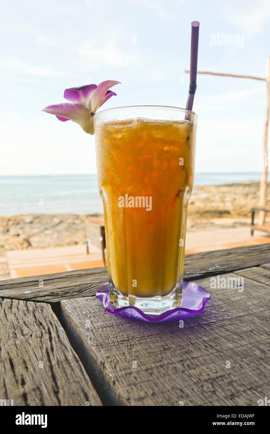 Fresh Mango juice in restaurant bar with sea behind. Thailand. Asia