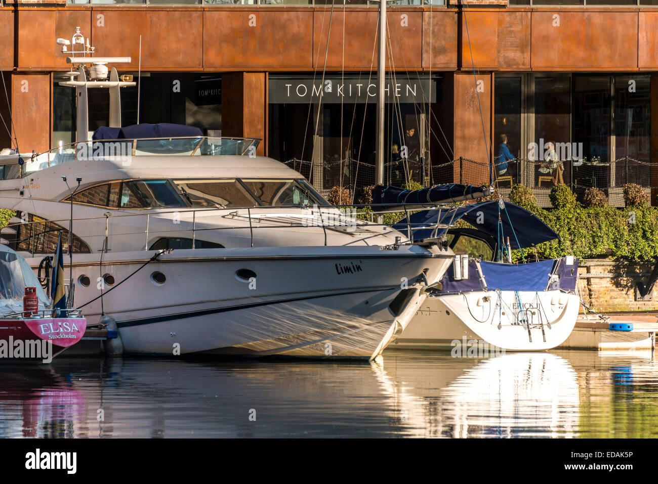 A luxury yacht moored in St Katharine Docks, East London, outside Tom's Kitchen restaurant. Stock Photo