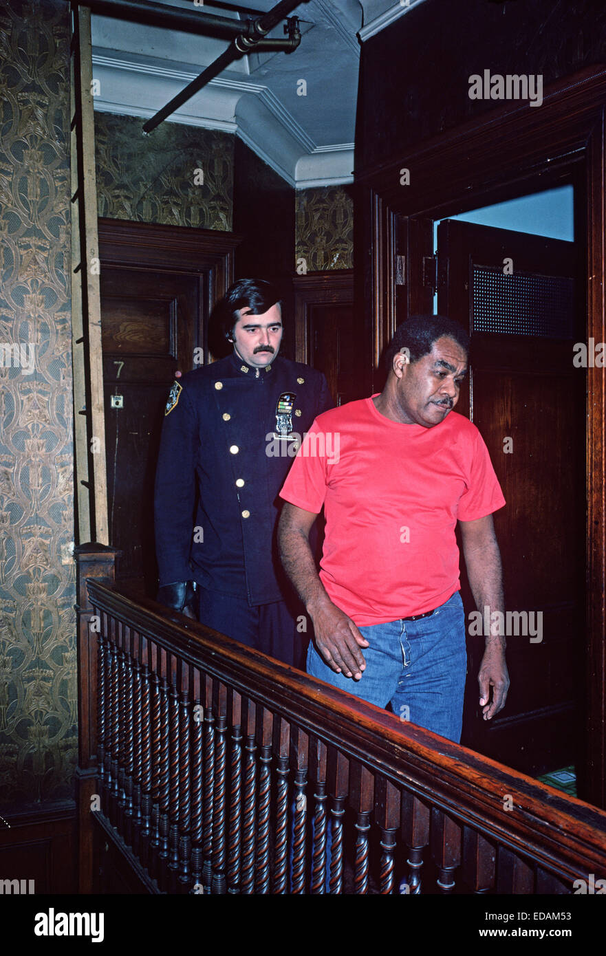 USA, HARLEM, NEW YORK CITY - APRIL 1978. 28th Precinct policeman arresting African American Stock Photo