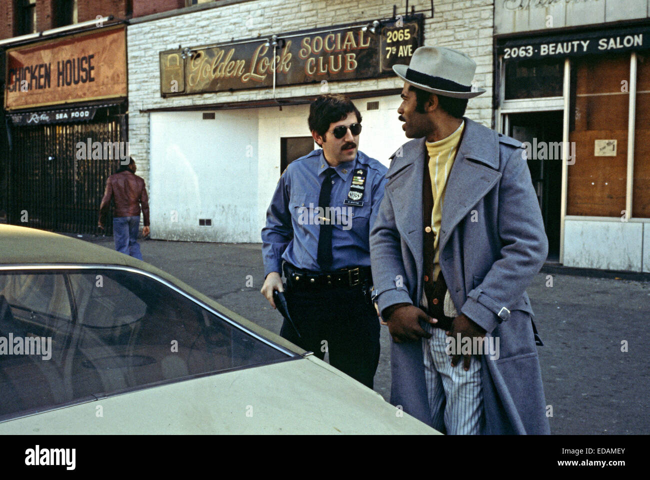USA, HARLEM, NEW YORK CITY - APRIL 1978. Harlem African American stop and search by 28th Precinct policeman, New York City. Stock Photo