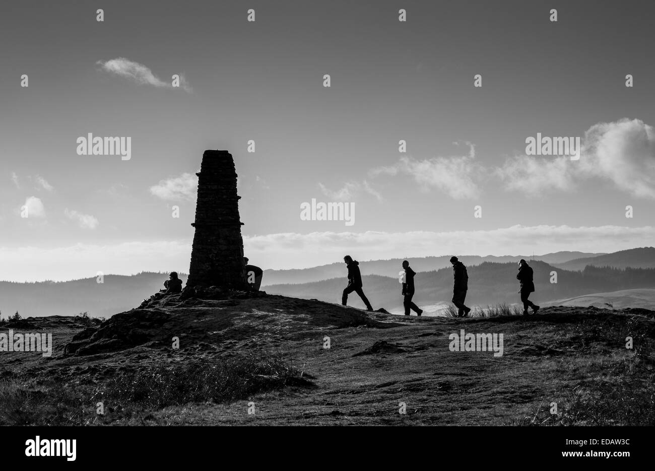 Walkers approaching the summit cairn on Latterbaroow, near Hawkshead, Lake District, Cumbria Stock Photo