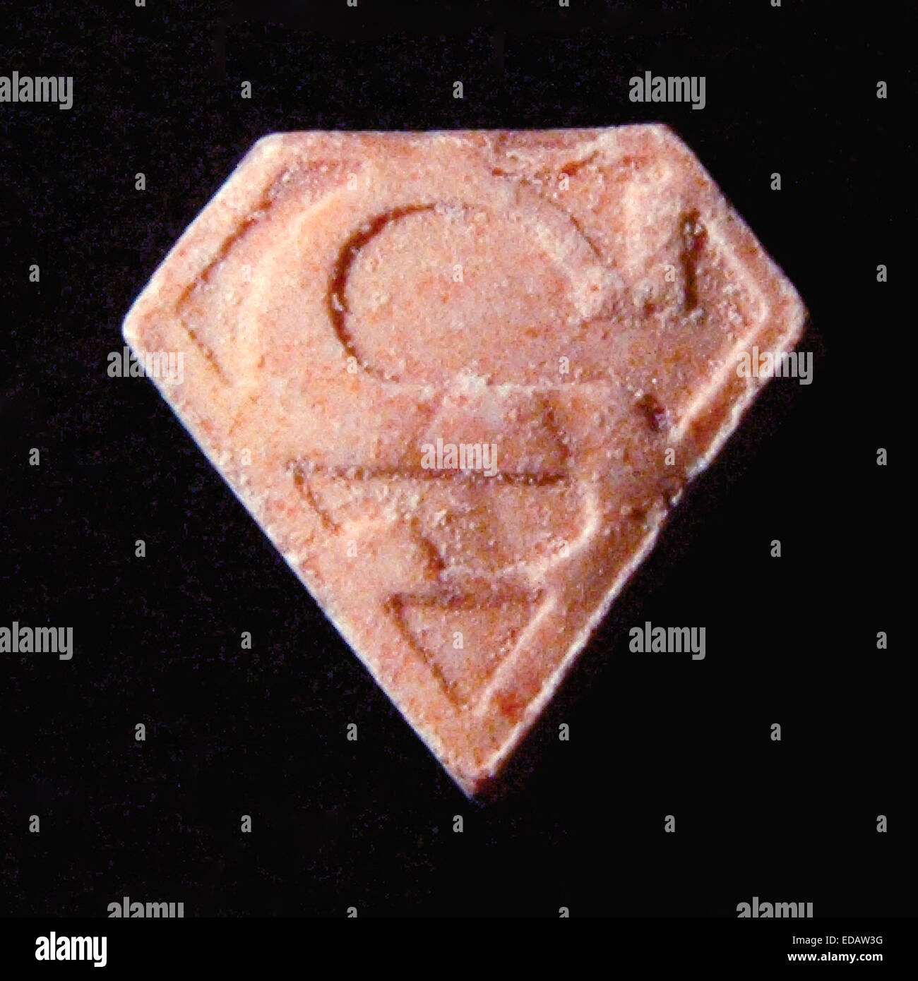 Fake Ecstasy pill know as a 'Pink Superman' containing PMA responsible for at least 4 deaths. This tablet would contain upwards of 173 mg of PMA, doses as low as 60 mg can cause significant and alarming increase in blood pressure, body temperature and pulse. High doses may cause vomiting, heart failure, kidney failure, brain seizures, hallucinations, sudden collapse, and an extreme rise in body temperature, up to 115°F (46°C).  See description for more information. Stock Photo