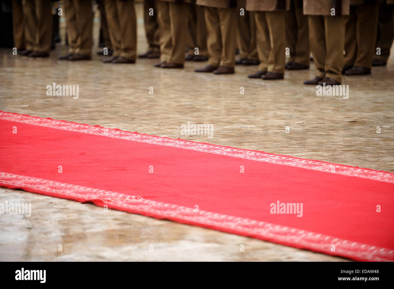 Guard of honor soldiers in front of the red carpet during military ceremony Stock Photo