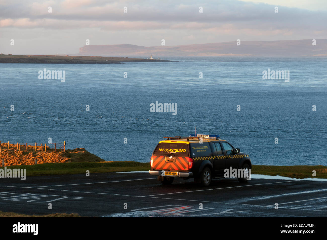Duncansby Head, Caithness, Scotland. 04th Jan, 2015. HM Coastguard vehicle at Duncansby Head as the search continues for the missing crew from the cargo ship Cemfjord which sank in the Pentland Firth yesterday.  In the distance, over the Pentland Firth, is Hoy in the Orkney Isles and the island of Stroma with its lighthouse. At Duncansby Head, Caithness, Scotland. Stock Photo