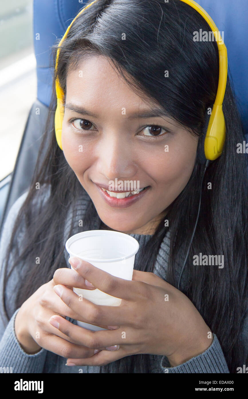 young woman riding on the bus and drinking coffee Stock Photo Alamy