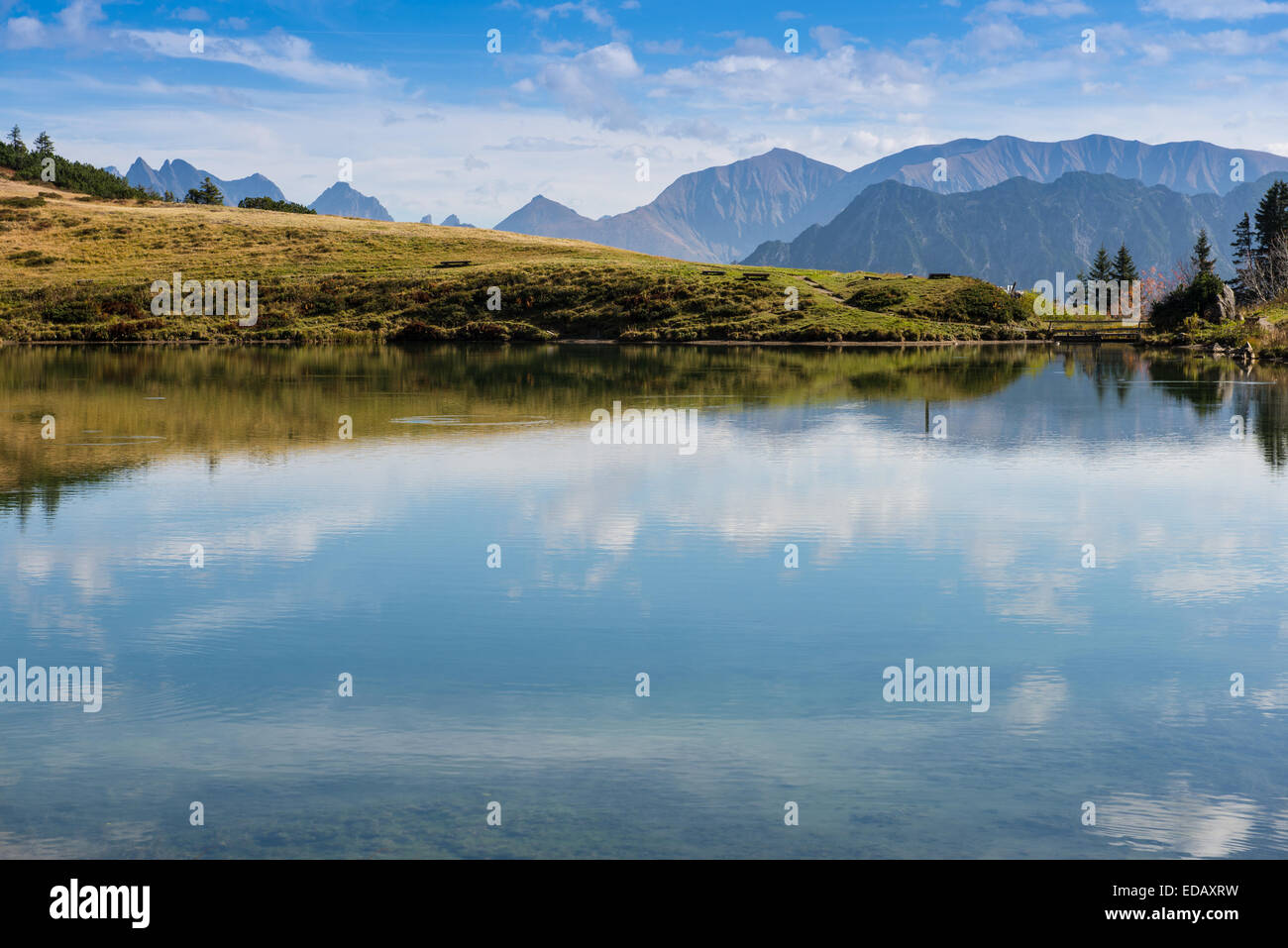 Mountain lake with reflection of the sky and clouds Stock Photo - Alamy