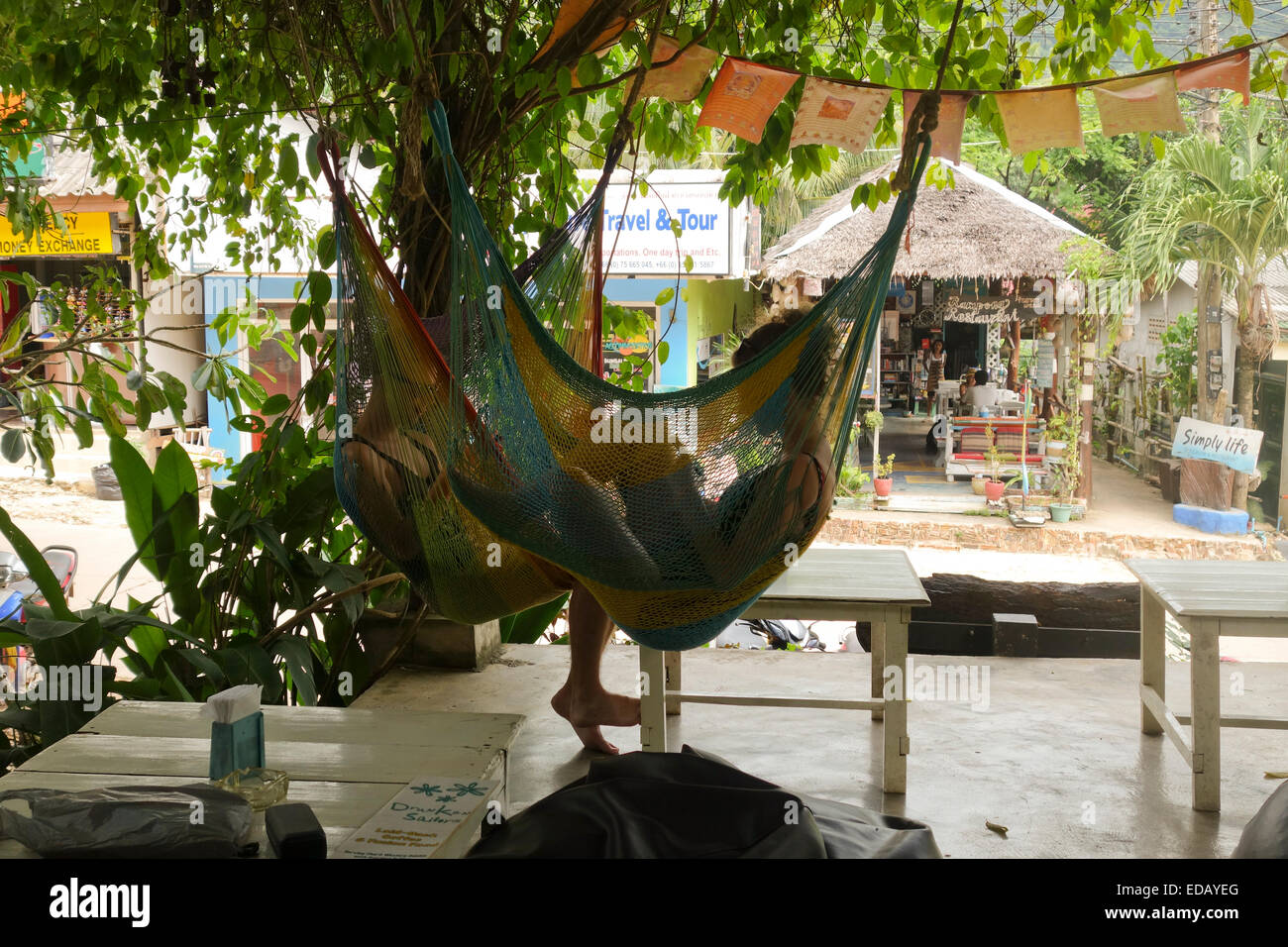 Young couple in hammocks in bar restaurant  Koh Lanta Thailand, Southeast Asia. Stock Photo