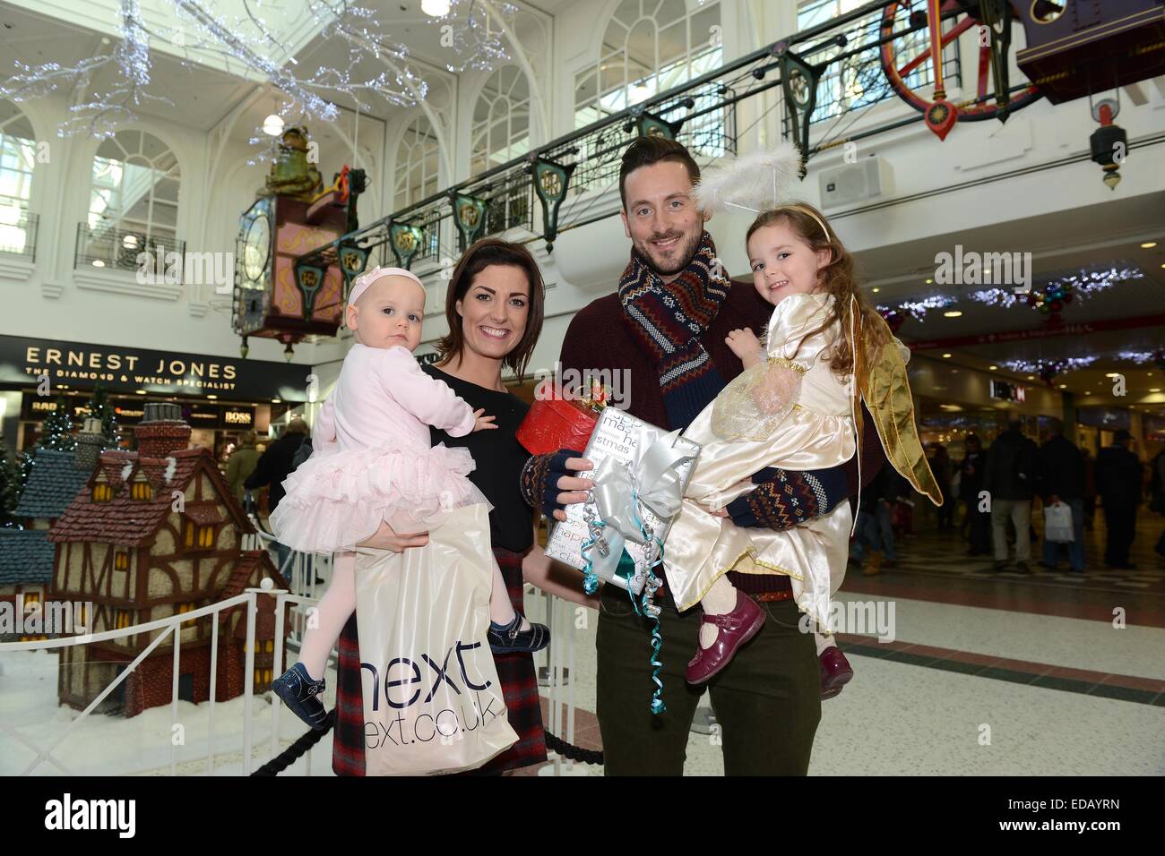 Telford Town Centre christmas feature SHOPPERS Steven and Sally McGlynn with Ava 3 & Sofia 15 monthsÊ Stock Photo