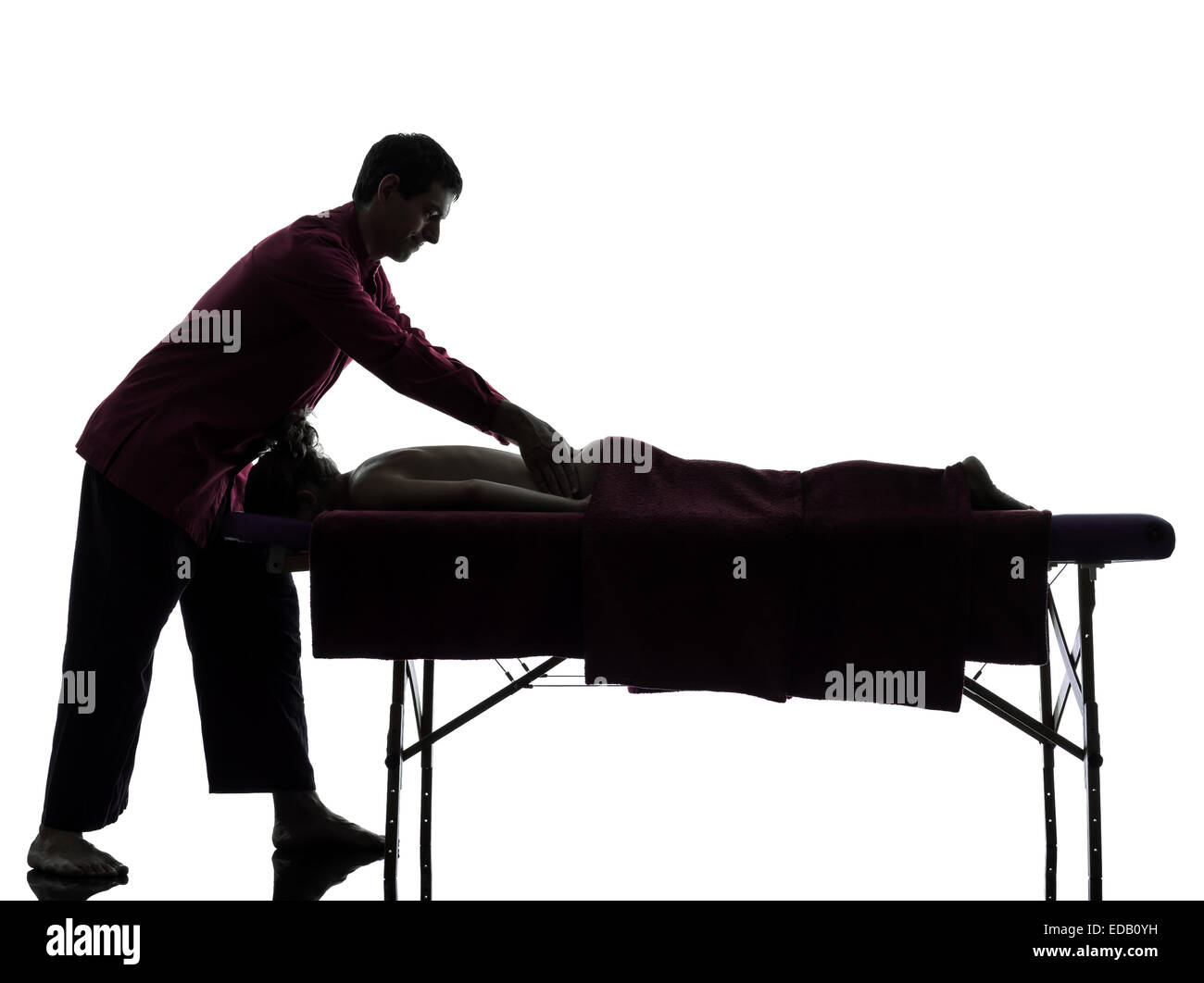 man woman back massage in silhouette studio on white background Stock