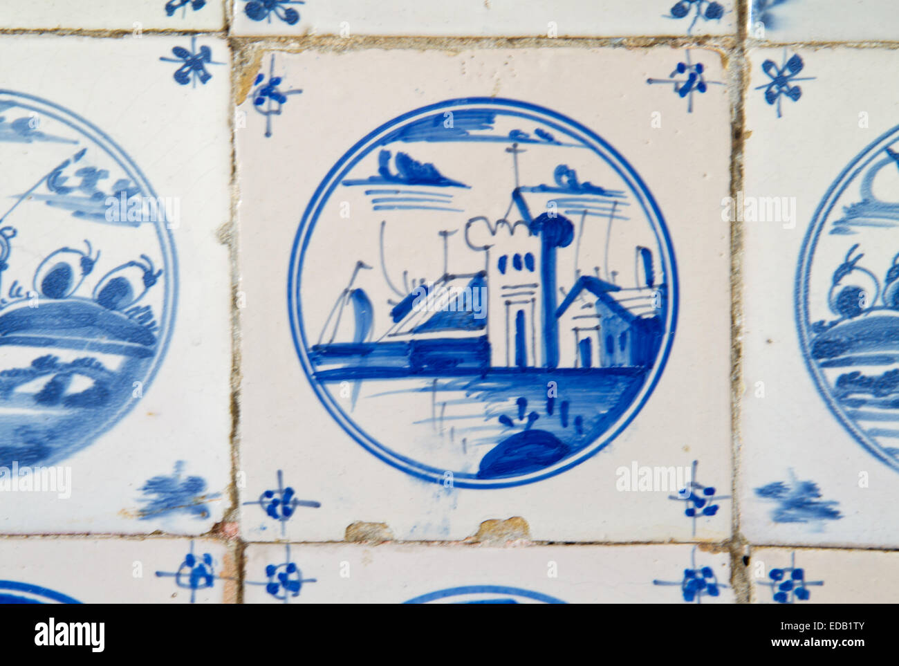 Painting of a church or castle on an antique dutch tile on the kitchen wall of an old building Stock Photo