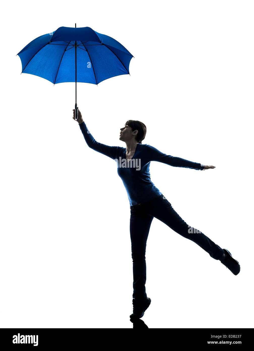 one  woman holding wind blowing umbrella in silhouette studio isolated on white background Stock Photo