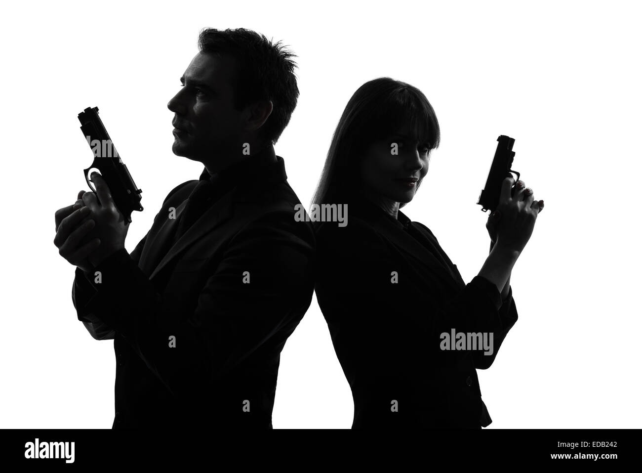 couple woman man detective secret agent criminal with gun in silhouette studio isolated on white background Stock Photo