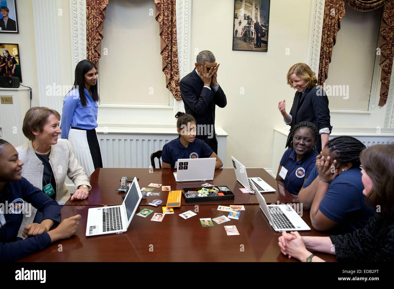 US President Barack Obama mimics a middle-school student overcome with emotion at meeting him during an Hour of Code event to honor Computer Science Education Week at the Eisenhower Executive Office Building December 8, 2014 in Washington, DC. Stock Photo