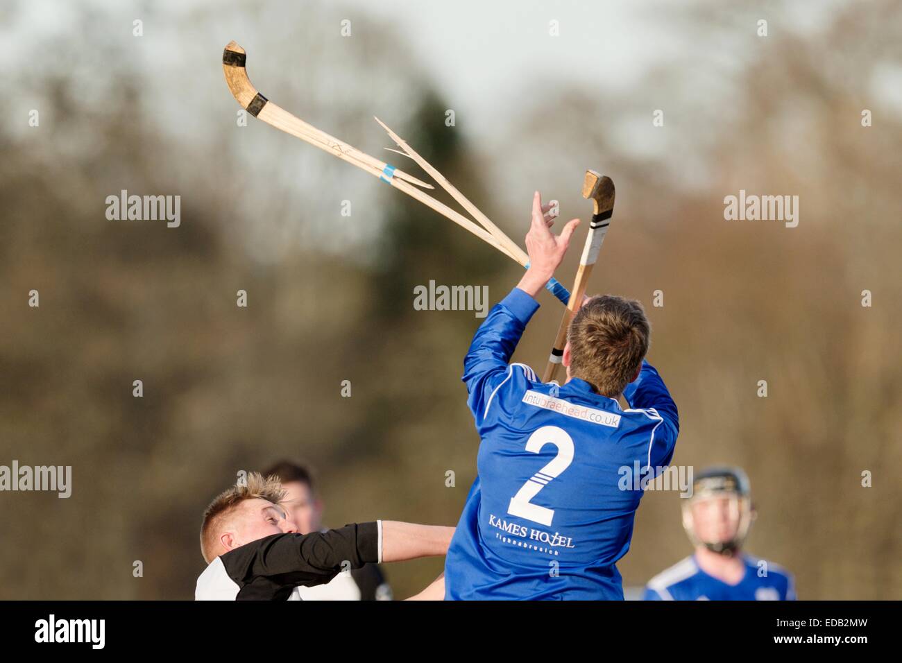 Kyles' Donald Irvine gets his stick broken in a challenge.  Lovat v Kyles Athletic in the Orion Group Premiership Shinty game. Stock Photo