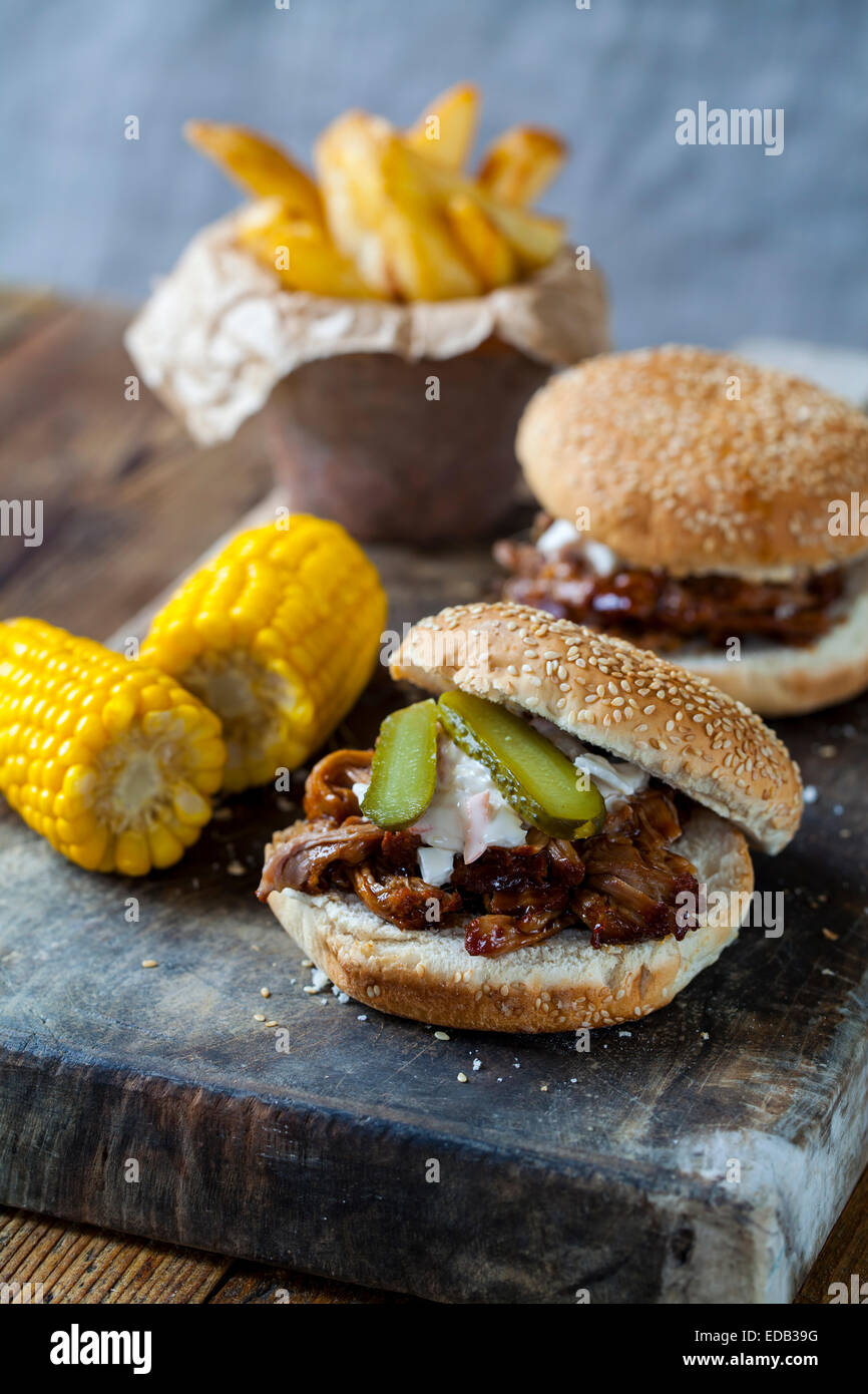 Burger with pulled pork, sweetcorn and chips Stock Photo