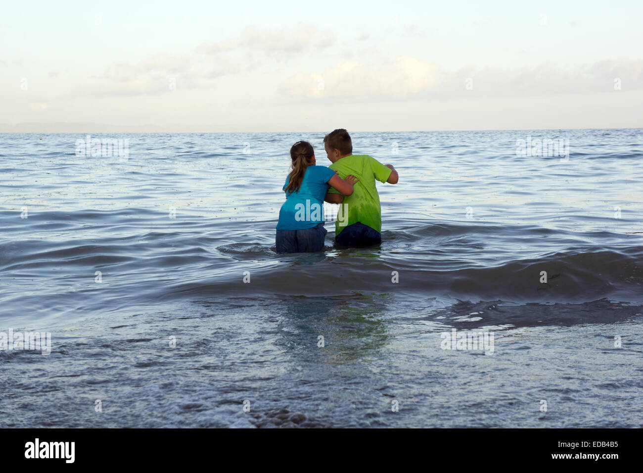 Two children playing in the sea Stock Photo - Alamy