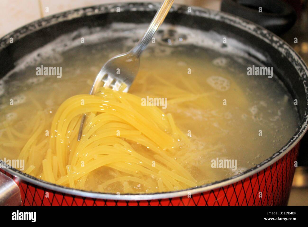 cooking pasta in the boiling water Stock Photo Alamy