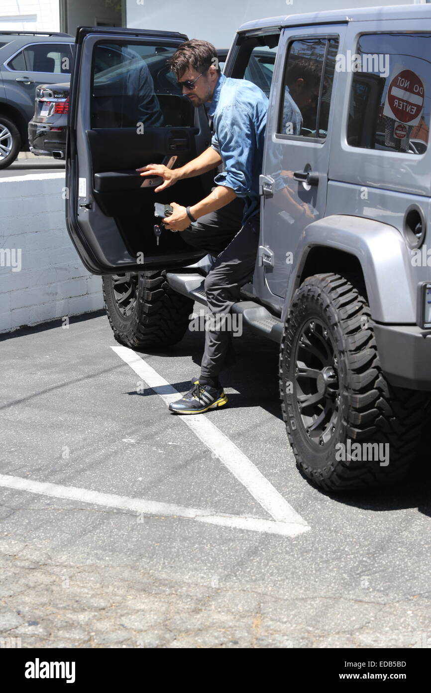 A bearded Josh Duhamel parks his Jeep and visits his office in
