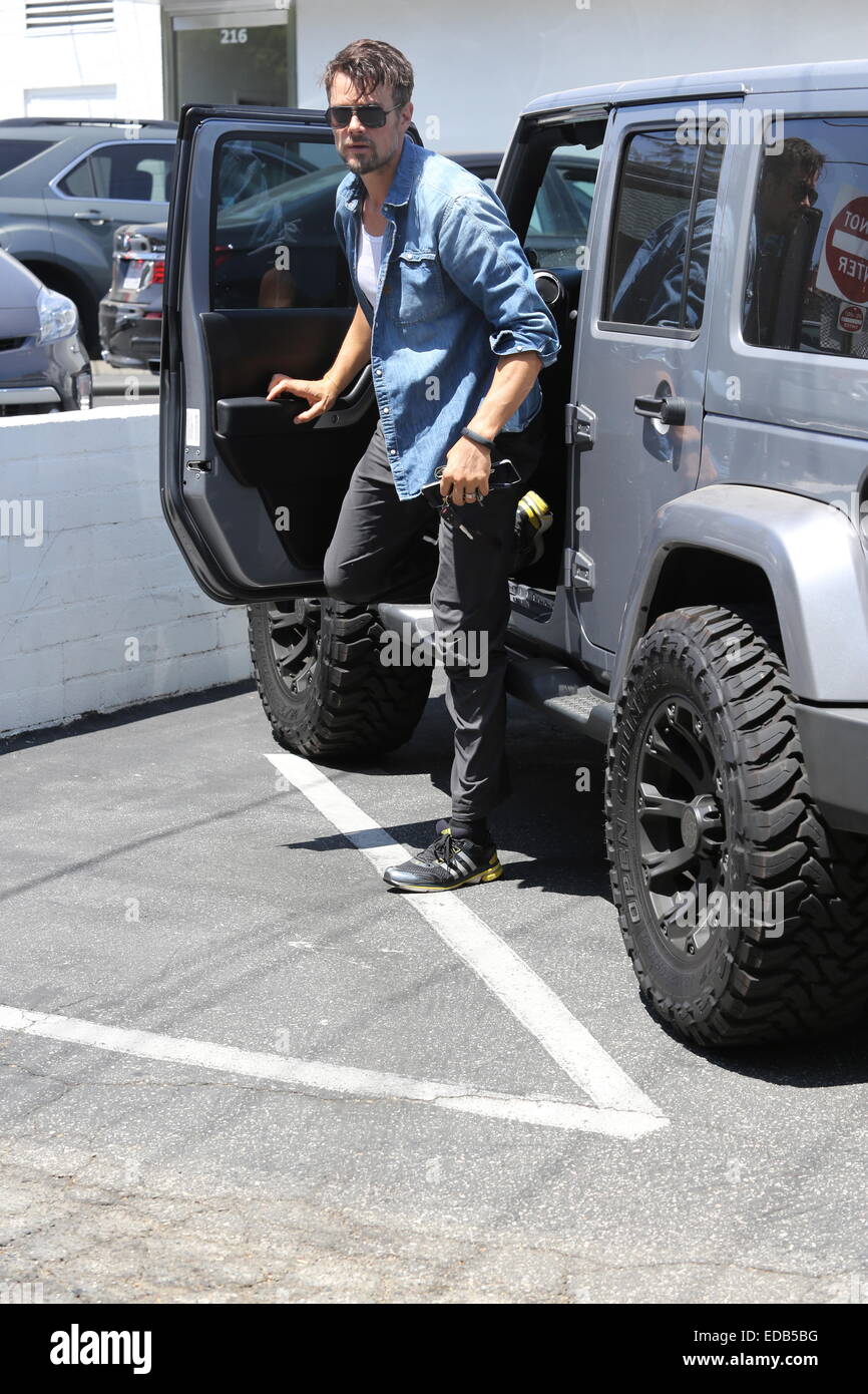 A bearded Josh Duhamel parks his Jeep and visits his office in