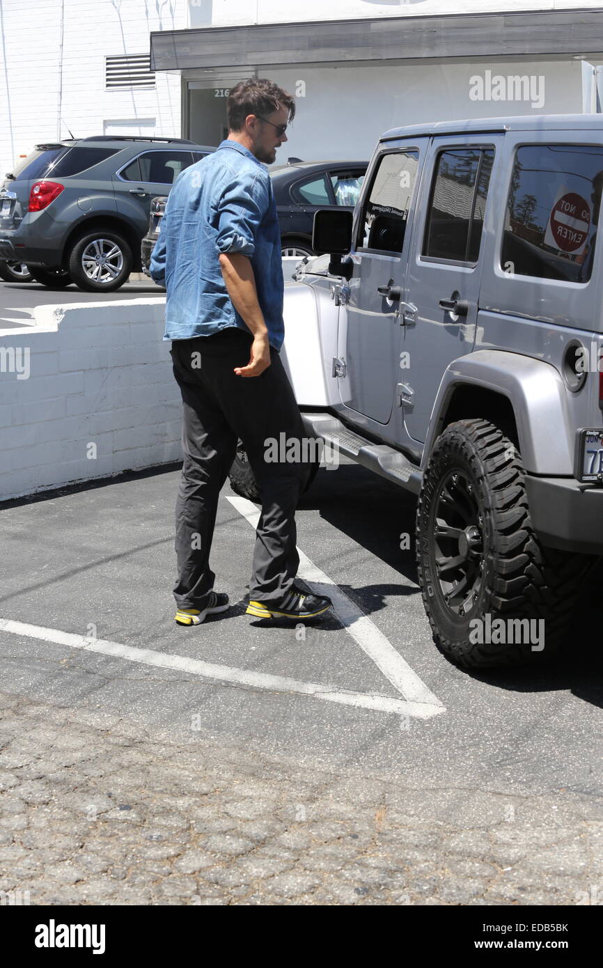 A bearded Josh Duhamel parks his Jeep and visits his office in